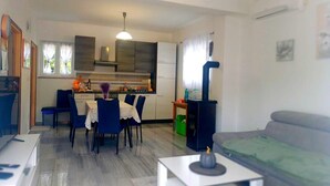 A compact living space with a dining area, kitchen, and a sofa. - "Waldhaus" in der Nähe des Strandes by Interhome (Rab/Kampor)