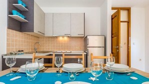 A modern kitchen with a dining area set for four. - "Vila Chiara" mit Pool by Interhome (Crikvenica/Dramalj)
