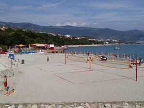A beach volleyball court with a net, a few people, and a view of the sea and mountains in the background. - "Ana" mit Blick auf das Wasser by Interhome (Novi Vinodolski)