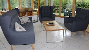 A modern living room with a grey sofa, two armchairs, and a wooden coffee table. - "Ferienwohnung ""Spel Rein"" Cumpadials" by Interhome (Cumpadials)
