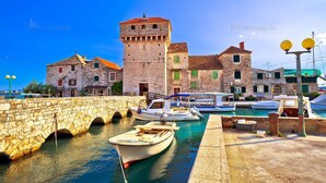 A stone bridge leading to a marina with boats docked. - Villa Antea by Interhome (Kaštel Sućurac)