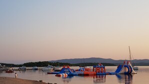 A marina with boats and inflatable play structures by the water. - Strandappartement Ana mit Meerblick, Garten, Grillplatz by Interhome (Dragišina)