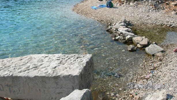 A rocky shoreline with clear water, a few people relaxing, and a date stamp of 22/07/2006. - "Kastil" mit privatem Pool by Interhome (Zrnovo)