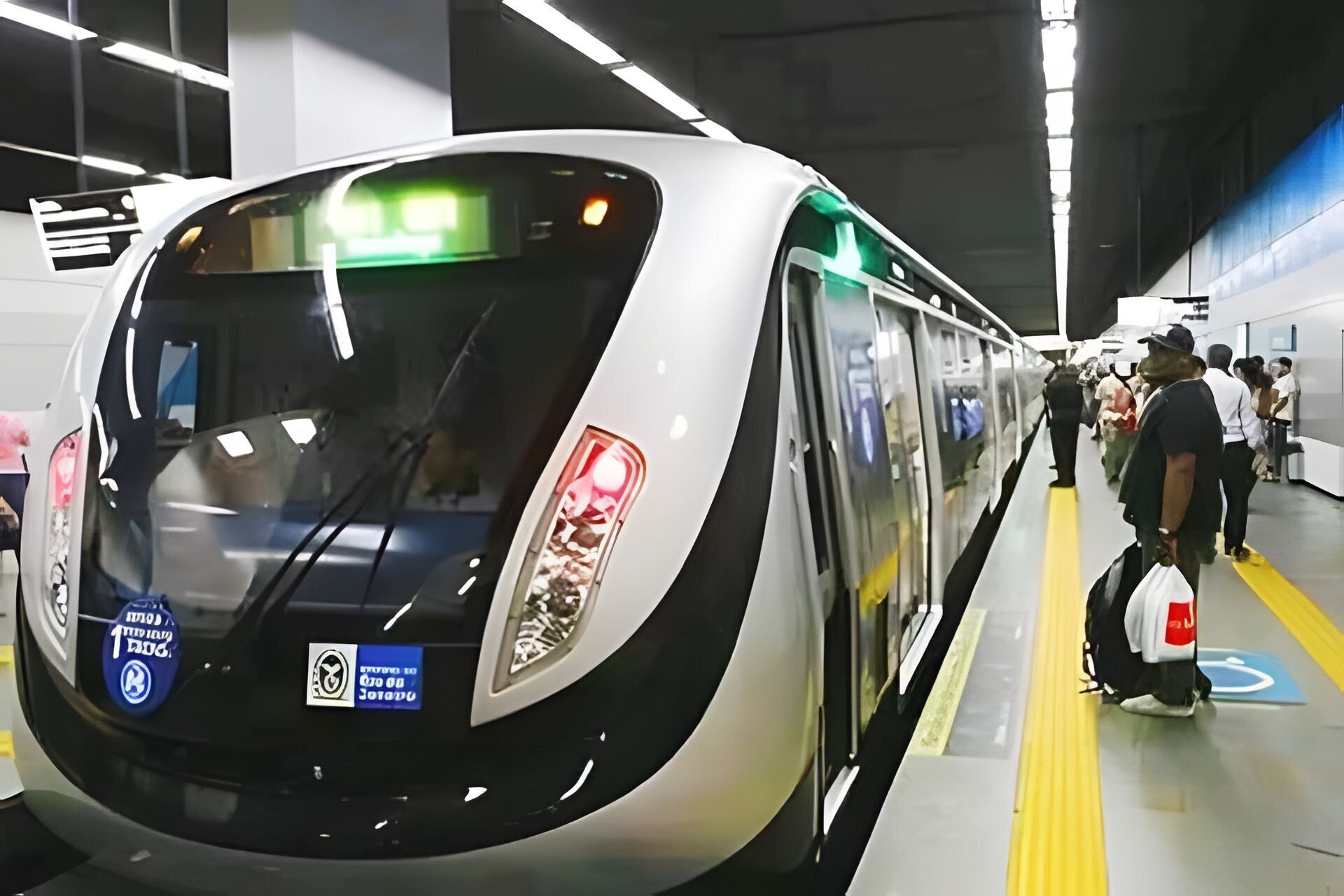 A modern train with a sleek design, featuring a prominent front window and a digital display.