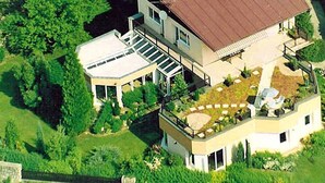 A modern two-story house with a flat roof, a covered patio, and a small deck. - Pool-Wellness JOSKA by Interhome (Mladá Boleslav)