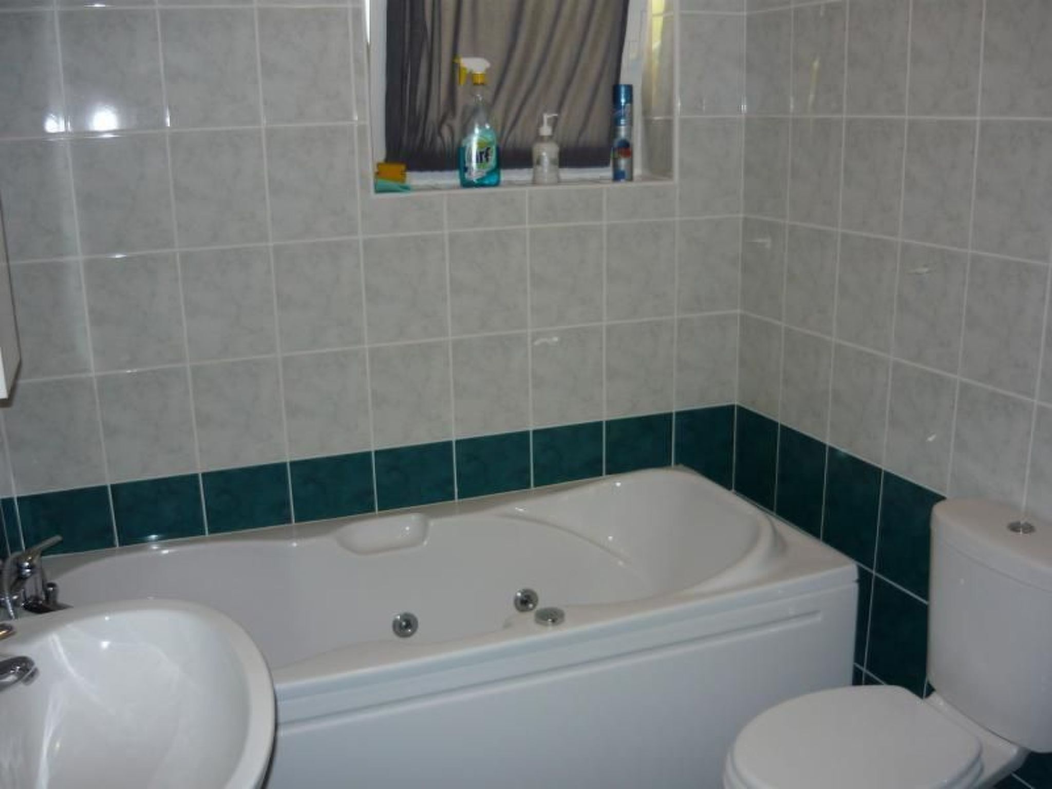A bathroom with a bathtub, sink, and toilet.