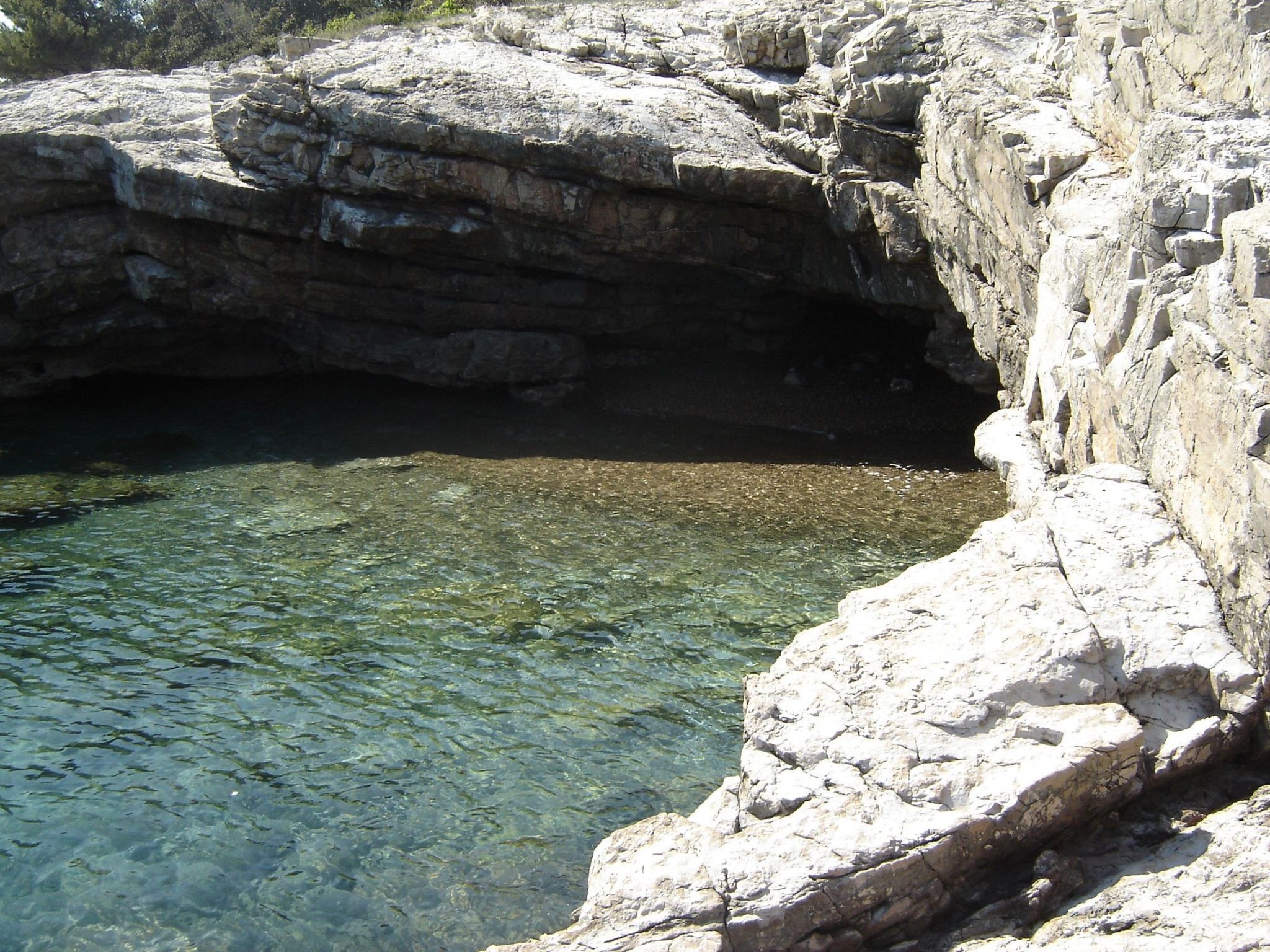 A rocky shoreline with clear water.