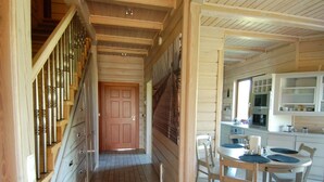 A wooden interior with a staircase, a dining area, and a kitchen. - Haus am Meer by Interhome (Krokowa)