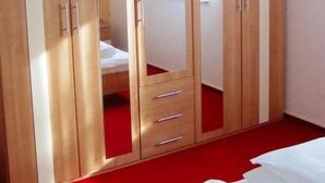 A bedroom with a large wardrobe, a bed, and a hanging light fixture. - Kottmarsdorf by Interhome (Kottmarsdorf)