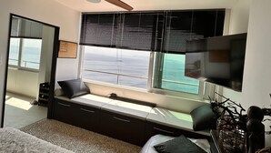 A bedroom with a large window, a ceiling fan, a bed, and a TV. - Wohnung Fiorino Rijeka, Kvarner Bucht by Interhome (Rijeka)