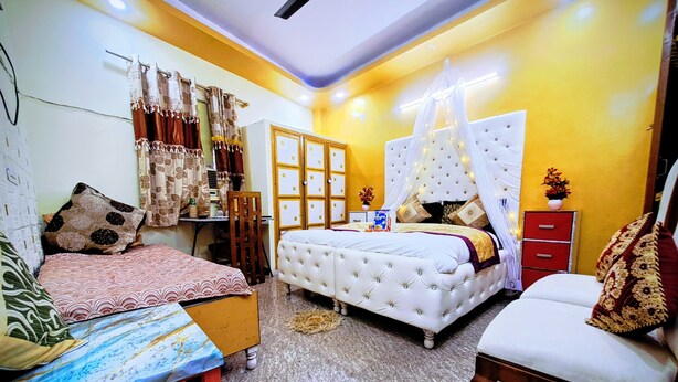 A bedroom with two beds, a desk, and a wardrobe. - THE DEEP GANESHA INN (New Delhi)