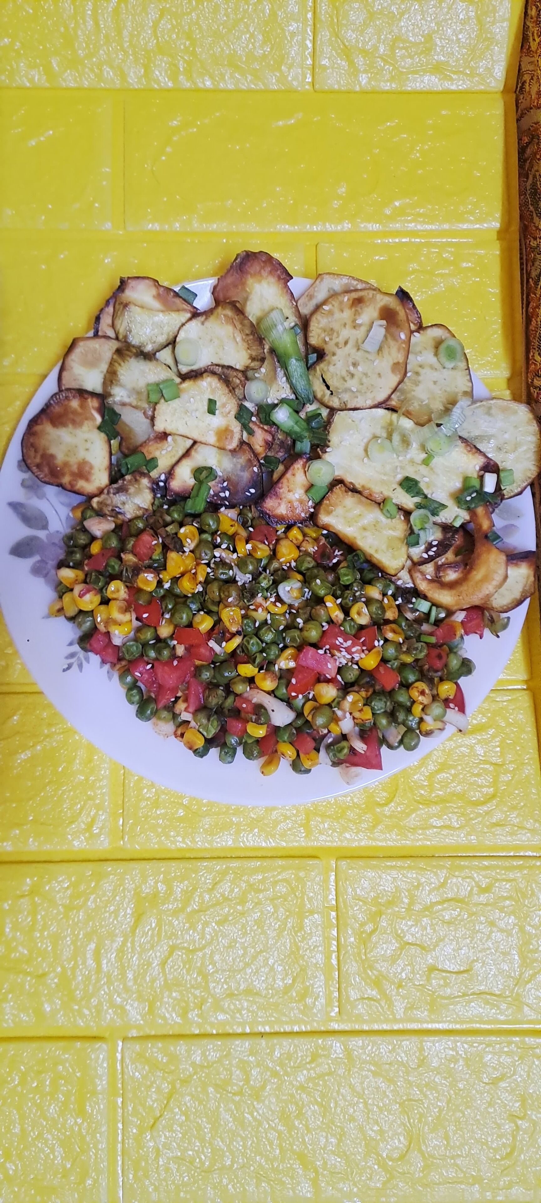 A plate of food with bread and a vegetable mix on a yellow surface.