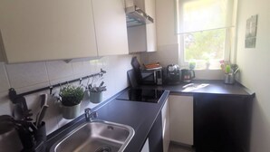 A modern kitchen with a stainless steel sink, a kettle, and a toaster. There is a window providing natural light. - Summer escape Rovinj by Interhome (Rovinj)