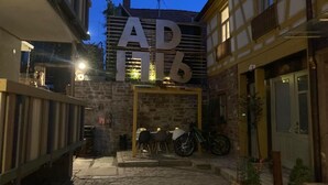 A courtyard with a stone floor, a bike parked outside, and a sign with the letters "AD" and "IT" illuminated. - Gäuls-Stadl by Interhome (Marktheidenfeld)