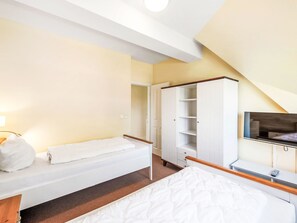 A hotel room with a bed, a wardrobe, a television, and a bathroom. - Reethaus Mertinat ''For Six'' mit Meerblick by Interhome (Gollwitz (Insel Poel))