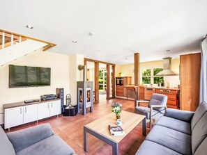 A modern living room with a fireplace, a television, and a sofa. - Reethaus Mertinat ''For Six'' mit Meerblick by Interhome (Gollwitz (Insel Poel))