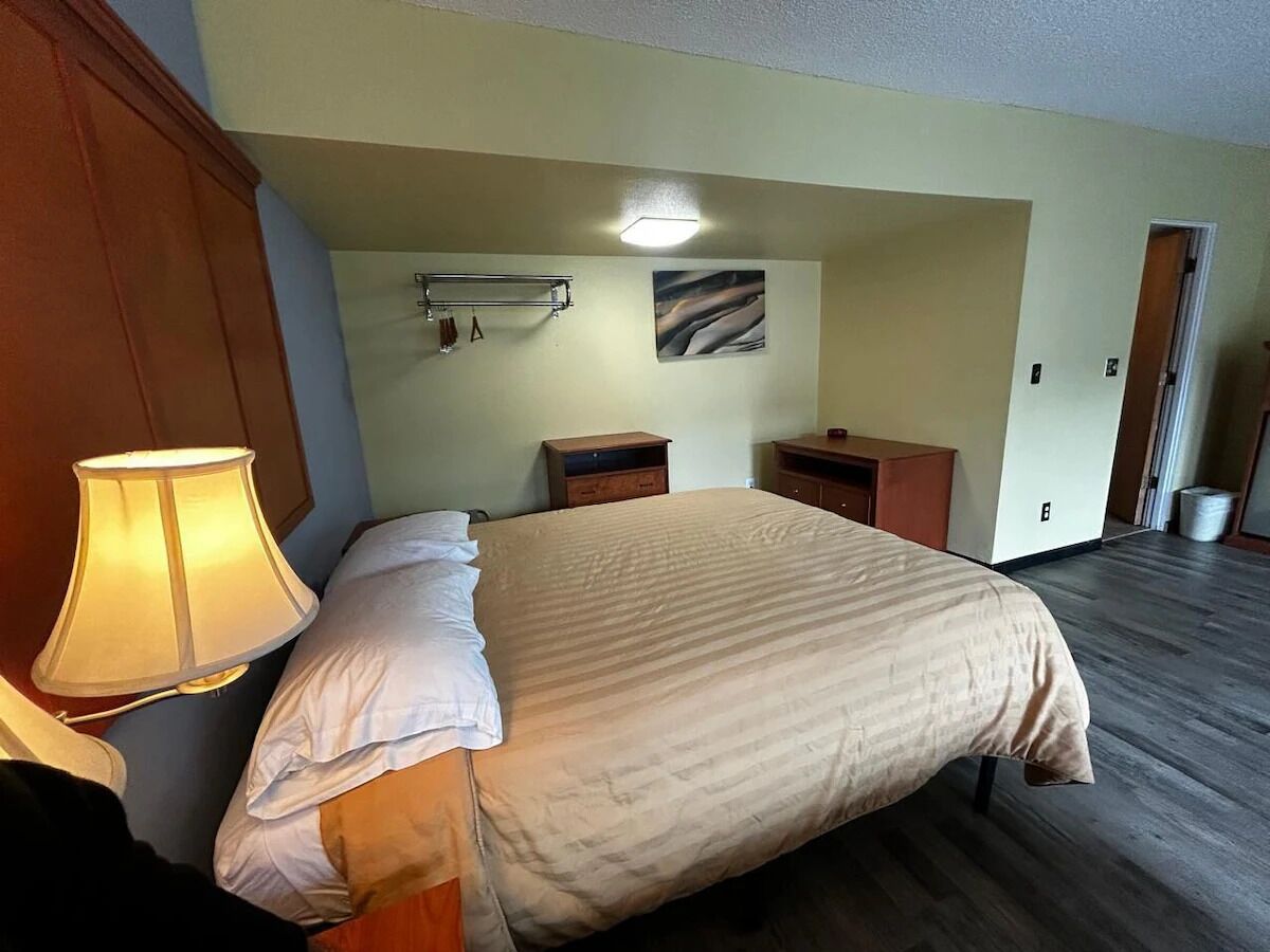 Drift off comfortably with soft bedding and warm bedside light.
