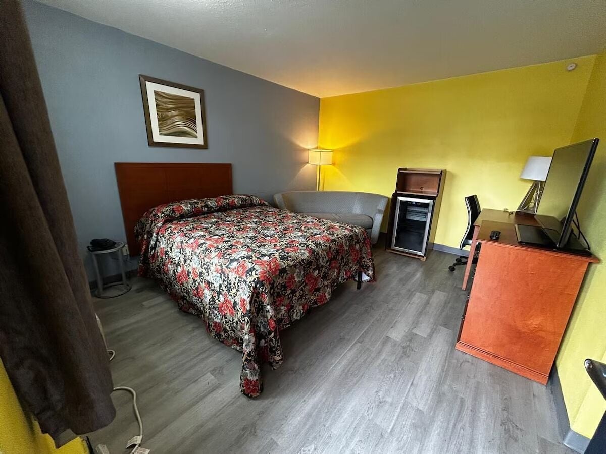 Unwind in a bright room with cozy seating and TV.