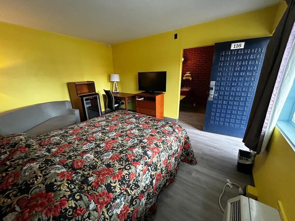 Settle into a spacious room with desk, TV, and sofa.