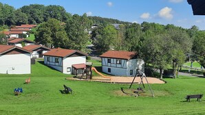 Un quartier résidentiel avec des maisons, une aire de jeux et un terrain herbeux.