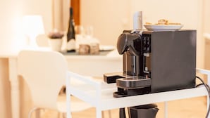 A coffee machine on a white table with a plate of food on top. - FeWo "Mosel Hygge" by Interhome (Winningen)