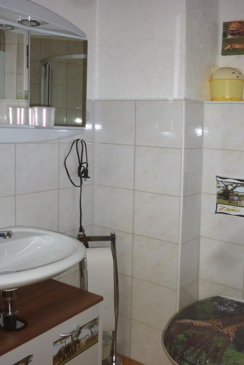 A bathroom with a sink, mirror, and toilet.