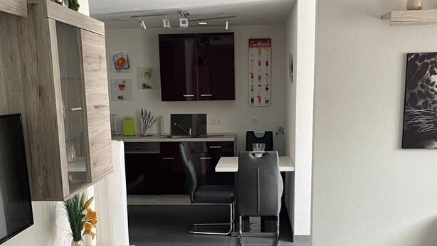 A modern living room with a flat-screen TV, a wooden coffee table, and a sofa. - in ruhiger Lage in Seenähe by Interhome (Oberteuringen)