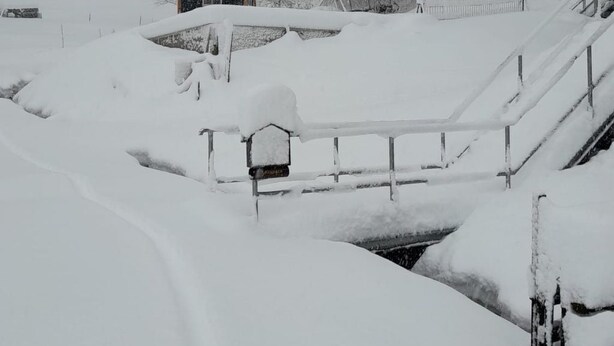 A snow-covered landscape with a small cabin, a wooden bridge, and a fence. - Mit der Natur im Einklang by Interhome (Neuhausen)