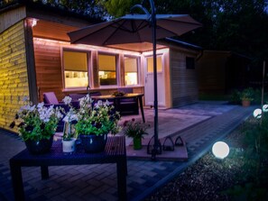 A patio area with a table and chairs, surrounded by potted plants. - Vacation home Martin by Interhome (Seeburg)