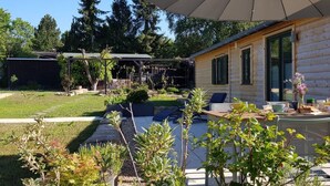 A log cabin with a patio area, outdoor seating, and a pergola. - in Atzenhain mit Großer Terrasse by Interhome (Atzenhain)
