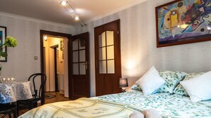 A hotel room with a bed, a chair, a table with candles, and a painting on the wall. - Wohnung mit Terrasse, Garten und Grill by Interhome (Myslakowice)