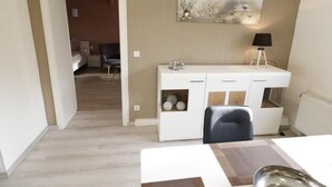 A modern room with a white desk, a chair, a lamp, and a painting on the wall. - Urlaub und zu Hause by Interhome (Naundorf)