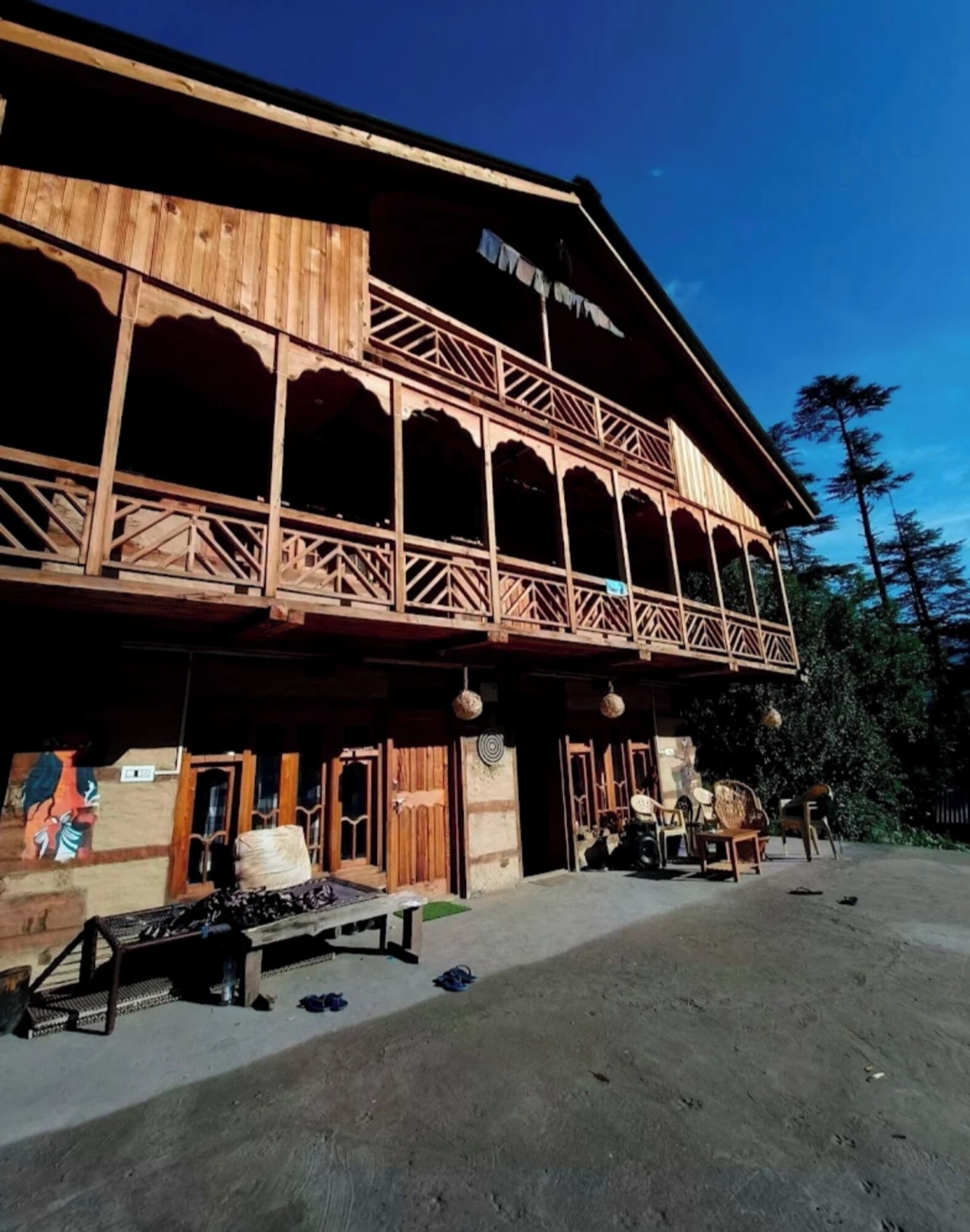 A wooden building with a balcony and a sign that reads "Hotel".