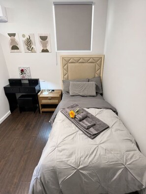 A bedroom with a bed, a desk, a nightstand, and a window. - 2BR Family-Friendly Stay Near Santa Anita, Caltech (San Gabriel)