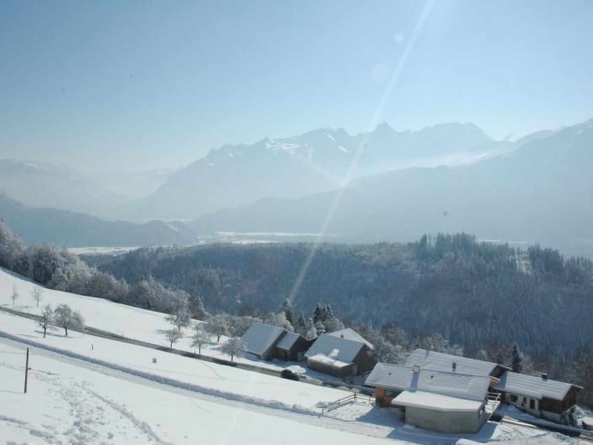 A snow-covered mountain landscape with a clear sky.