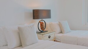 A hotel room with two beds, a nightstand, a lamp, and a decorative item. - Villa 7 - Luxury Private Pool Villa (Langkawi)