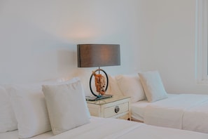 A hotel room with two beds, a nightstand, a lamp, and a decorative item. - Villa 7 - Luxury Private Pool Villa (Langkawi)