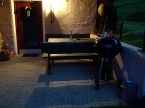 An outdoor seating area with a bench and a barbecue grill. - am Wallnerhof in Flattach by Interhome (Flattach)