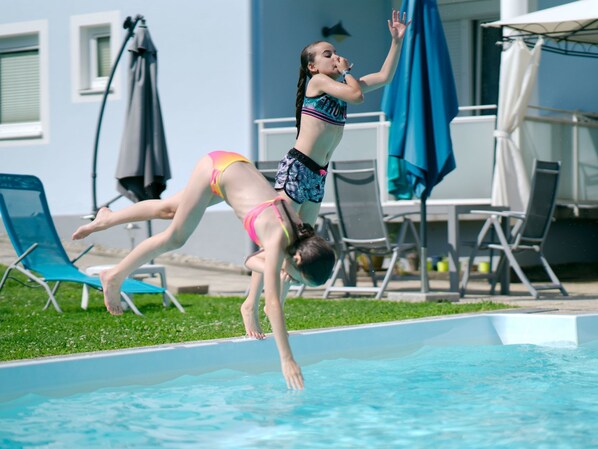 A person diving into a swimming pool.