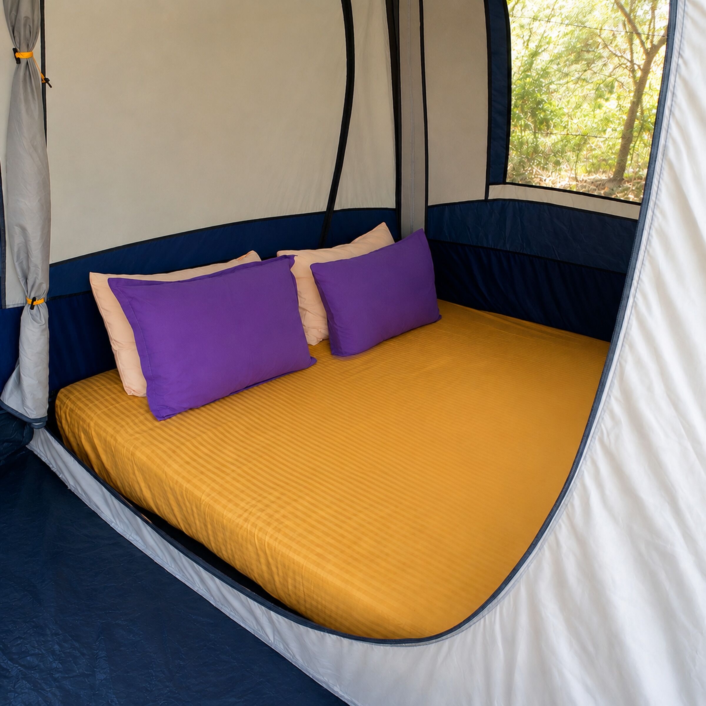 A tent with a bed, two pillows, and a window.