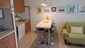 A compact kitchen with a dining area, a sofa, and a small table with chairs. - Strandnahe Ferienwohnung mit großer Terrasse by Interhome (Brač/Postira)
