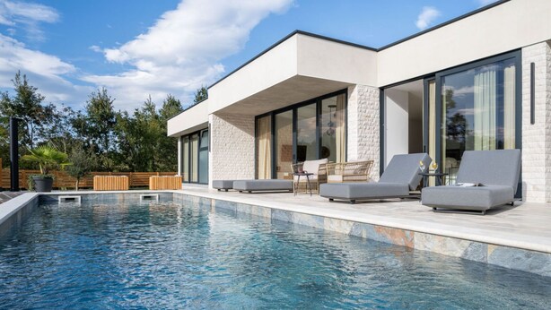 A modern house with a swimming pool, large windows, and outdoor seating. - Sunset Villa Santalezi by Interhome (Nedescina)