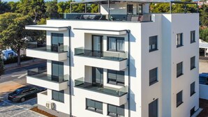 A modern multi-story building with balconies, large windows, and a flat roof. - Wohnung Bruno - Luxuriöses Penthouse by Interhome (Zadar)