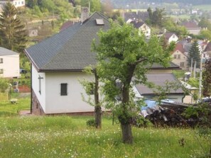 A single-story house with a sloped roof, surrounded by a grassy area with trees. - Villa "Na Hora" mit Garten, Grill und Terrasse by Interhome (Malé Svatonovice)