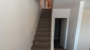 A staircase leading to a landing with a door at the top.