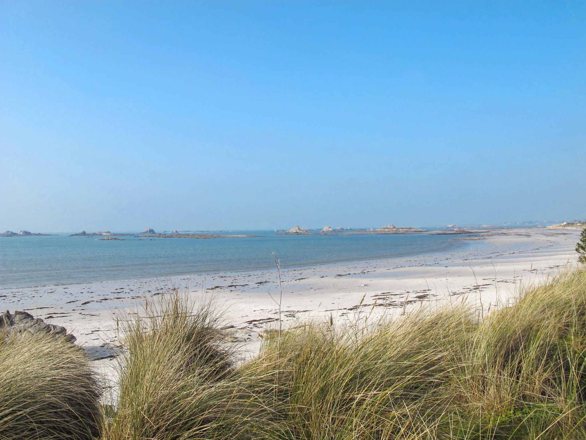 A beach with clear skies and calm waters.