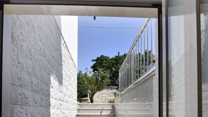 A modern staircase with stone steps and metal railings, leading to an outdoor area with trees and a clear sky. - Geräumige Kellerwohnung in der Nähe von Umag by Interhome (Umag)