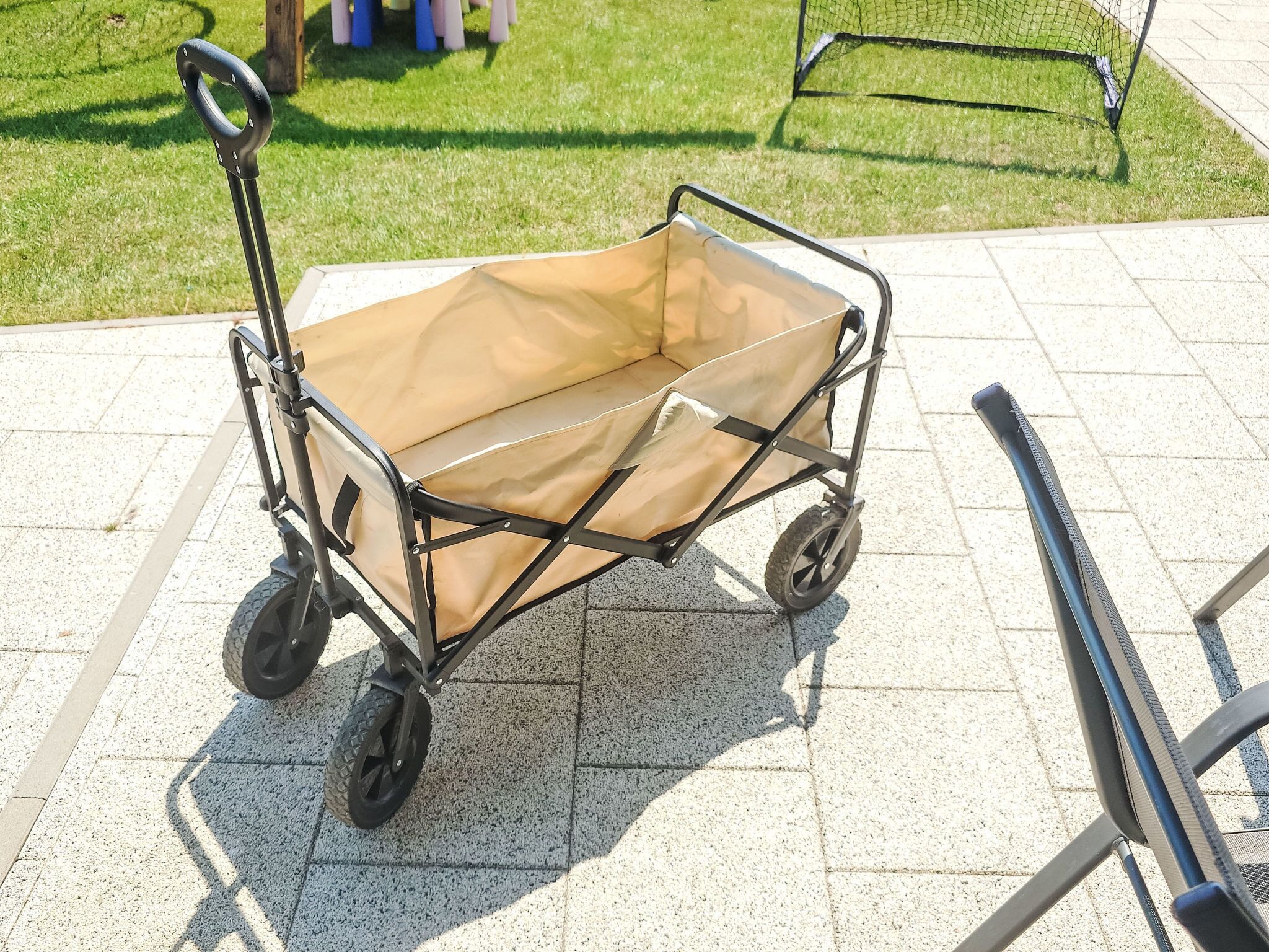 A portable cart with a canvas cover, wheels, and a handle.
