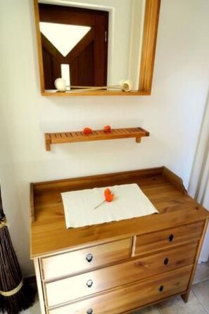 A wooden dresser with drawers and a mirror above it. - Fewo Ginkgo by Interhome (Dresden)