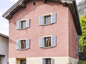 A multi-story building with four windows, each with shutters, and a flat roof. - Waterfall House by Interhome (Mesocco)